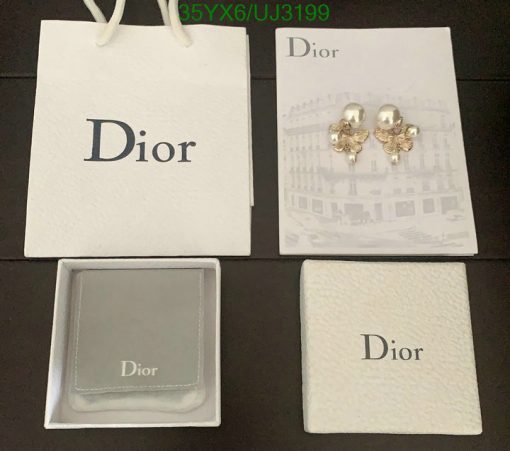 Dior branded packaging and pearl earrings on display.