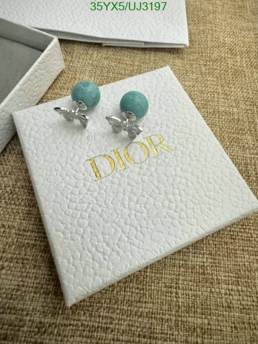 Turquoise bead earrings on white branded display card.