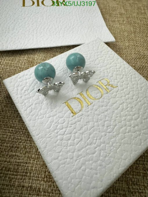 Turquoise Dior earrings on branded card.