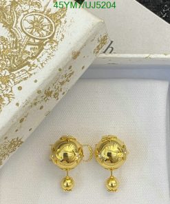 Gold designer earrings in decorative box.