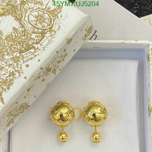 Gold designer earrings in decorative box.