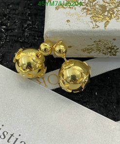 Gold spherical double-drop earrings on textured backdrop.