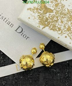 Golden Dior earrings on branded box with ribbon