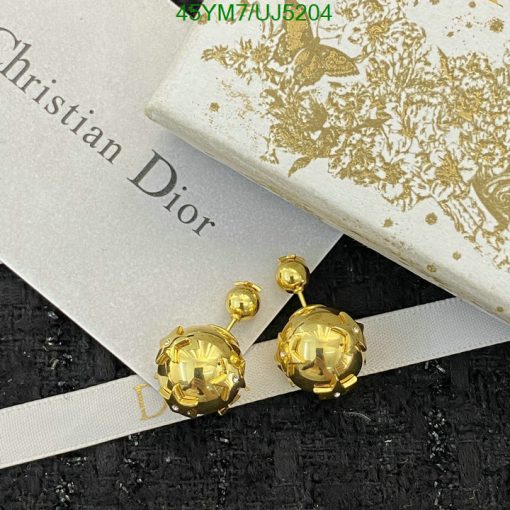 Golden Dior earrings on branded box with ribbon