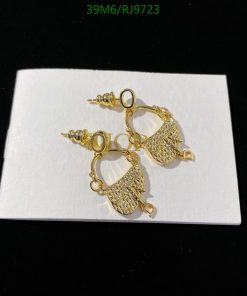 Gold filigree earrings on white background.