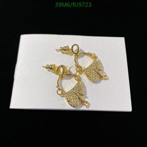 Gold filigree earrings on white background.