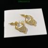 Gold textured earrings on white display card.