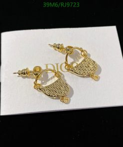 Gold textured earrings on white display card.