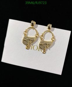 Gold hoop earrings with logo detail on display.