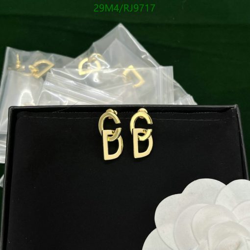 Gold buckle earrings on black display box