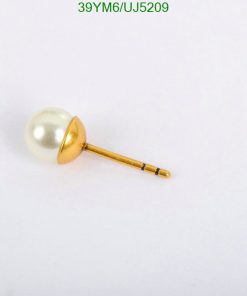 Gold pearl tie tack on white.