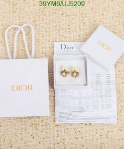 Dior earrings with packaging and receipt on textured background.