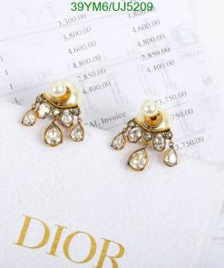 Elegant pearl and crystal chandelier earrings on paper.