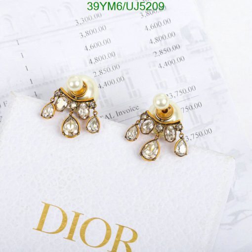 Elegant pearl and crystal Dior earrings on invoice.