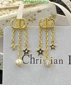 Designer gold earrings with stars, pearl, and diamond accents.