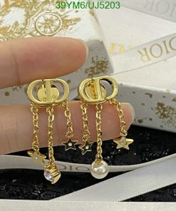 Gold star charm dangle earrings with box.