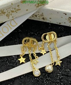 Gold star-themed dangle earrings with pearl accent.