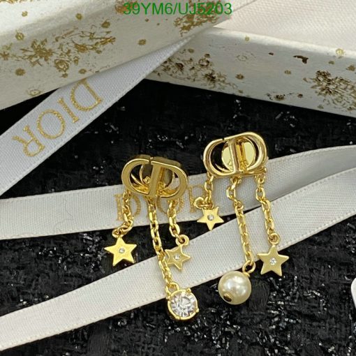 Gold star-themed dangle earrings with pearl accent.