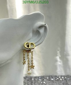 Gold hoop earring with star charms on mannequin ear.