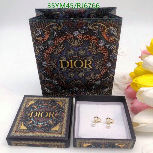 Dior branded jewelry box with earrings and packaging.