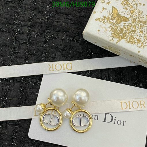 Dior pearl earrings on branded card with box.