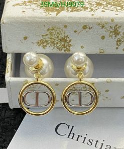 Pearl gold designer logo earrings on display.