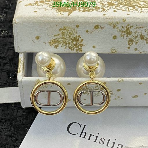 Pearl gold designer logo earrings on display.