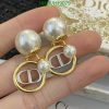 Pearl and gold-tone designer earrings