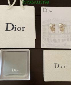 Dior branded packaging with pearl earrings and jewelry box.