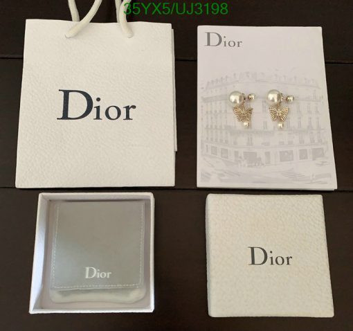 Dior branded packaging with pearl earrings and jewelry box.