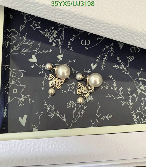 Decorative wall with butterfly and pearl accents.