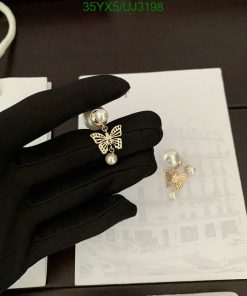 Pearl butterfly earrings on black glove