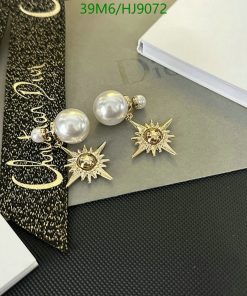 Pearl earrings with sunburst design on elegant background.