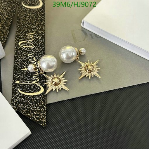 Pearl earrings with sunburst design on elegant background.