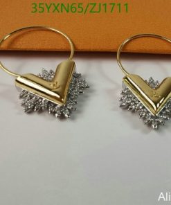 Gold and silver starburst hoop earrings.