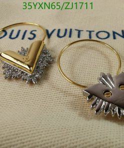 Designer gold-tone key rings on branded fabric.