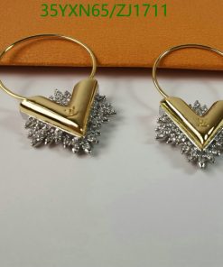 Gold and silver-toned starburst hoop earrings.