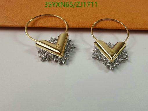 Gold and silver-toned starburst hoop earrings.