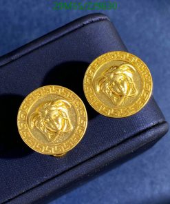 Gold lion head earrings on blue background.