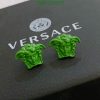 Green Medusa head earrings on Versace box.