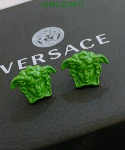 Green Medusa head earrings on Versace box.