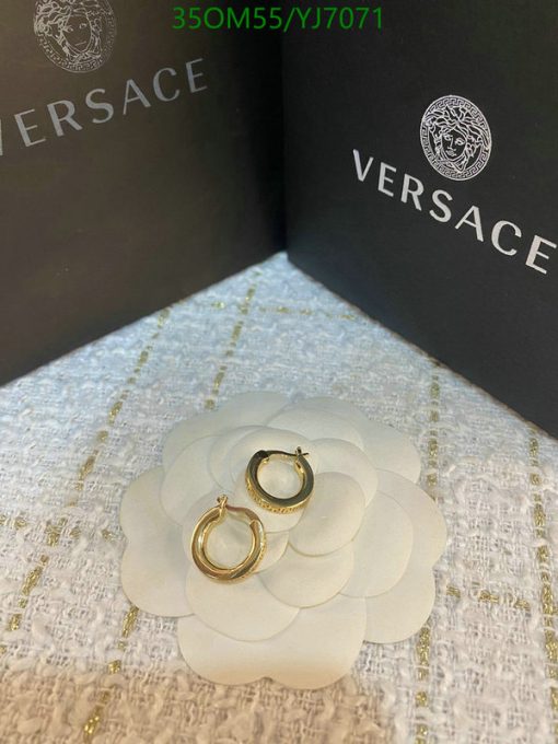 Versace gold hoop earrings with packaging.