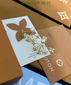 Designer logo earrings on branded packaging.