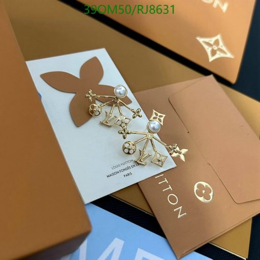 Designer logo earrings on branded packaging.