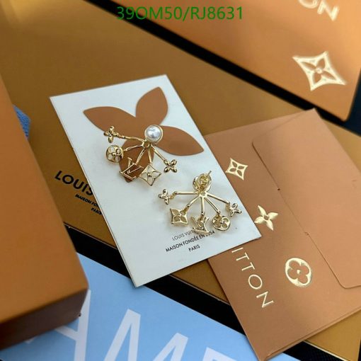 Elegant designer pearl and gold earrings on branded card.