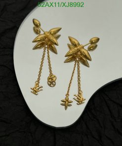 Gold starburst earrings with dangling chain charms.