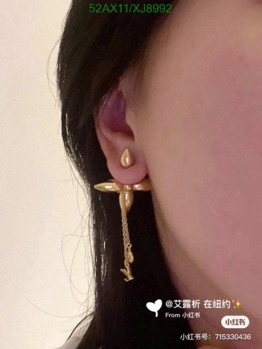 Woman's ear with unique gold dangle earring.