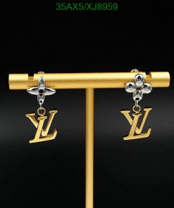 Designer logo drop earrings on display stand.