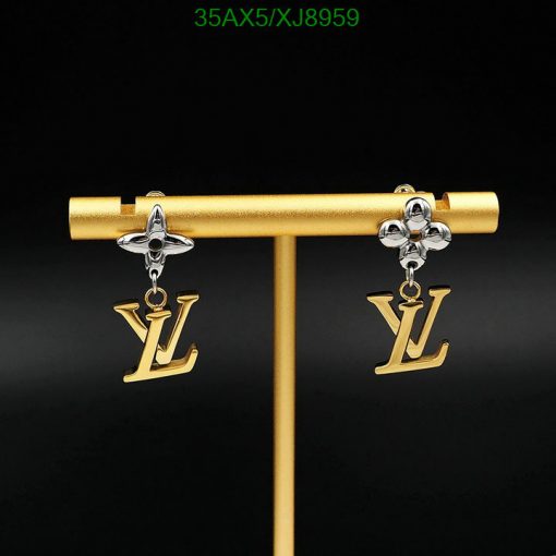 Designer logo drop earrings on display stand.