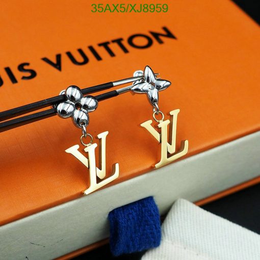 Designer earrings on Louis Vuitton book.